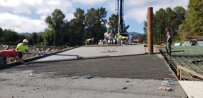Pouring of concrete boat ramp surface and texturing.